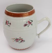 An 18th century Chinese porcelain barrel-shaped tankard; the rim with a gilded key-fret design above