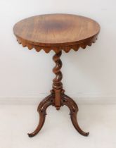 A mid-19th century circular-topped rosewood wine or occasional table: slightly faded top with darker