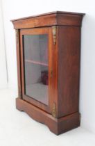 A figured walnut and gilt-metal-mounted pier cabinet: single glazed door below boxwood marquetry