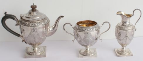 A fine hallmarked silver three-piece bachelor's tea service comprising teapot, sugar and milk jug.