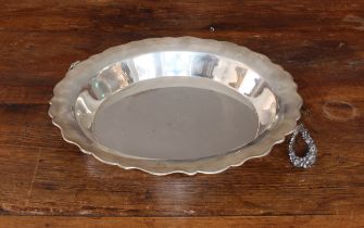 A large white metal bowl: two hinged floral cast handles and the outer-edge lip marked 'Patarca