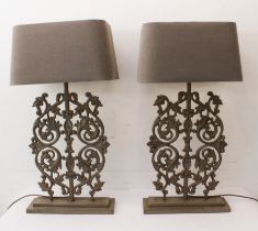A pair of painted cast-iron balustrade lamps: late 20th / early 21st century, on stepped wooden