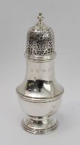 A modern hallmarked silver caster in 18th century style: pierced domed top above a baluster body and