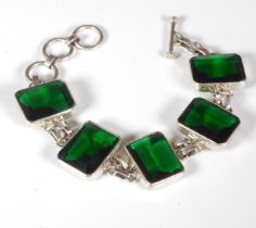 An attractive silver bracelet mounted with five hand-cut dark green stones in the style of