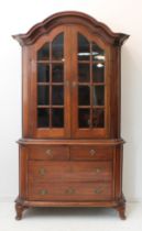 A 20th century pine display cabinet on chest in 18th century Dutch style: the arched outset