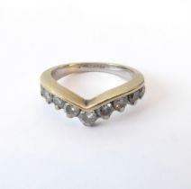 A 14ct yellow gold and diamond wishbone ring - set with nine graduated brilliant cut diamonds, total