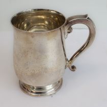 A heavy hallmarked silver tankard: baluster form, spreading circular foot and maker's mark of Adie