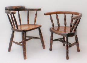 A matched pair of childs' captain's-style chairs. One late 19th century, in beech and oak with
