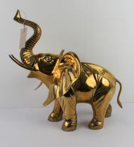 A heavy modern brass sculpture of a trumpeting tusker (41 cm high to tip of trunk x 39 cm wide)