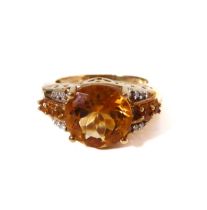 A 9-carat yellow gold dress ring: centrally set with a good sized hand-cut citrine flanked by two