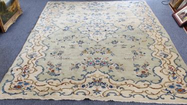 A Chinese carpet, circa 1930s; ivory ground with central medallion surrounded by blue floral