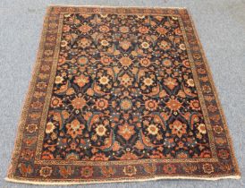 A circa 1900 north-west Persian Feraghan rug; dark-blue field with Herati design in blue and red