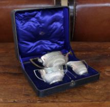 A three-piece hallmarked silver tea service in Georgian style in its original fitted case. Each
