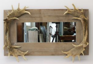 A faux-antler mounted wooden mirror: modern, 76 x 110cm.