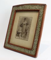 A large early 20th century mahogany photograph frame: with arched top and hand-carved and pierced
