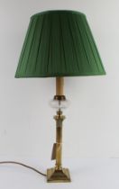 An early to mid 20th century brass oil lamp modelled as a Corinthian column and with etched clear-