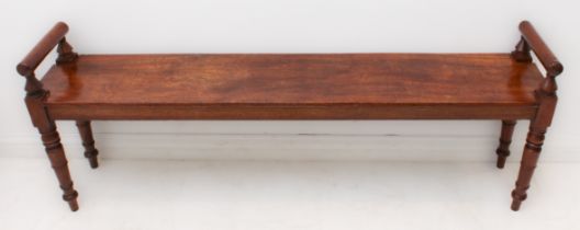 A William IV or early Victorian mahogany window seat: two turned handle ends affixing to a single