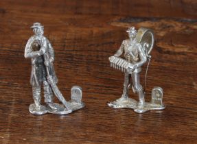 A rare pair of hallmarked silver figural menu holders/place settings modelled as a Quaker style
