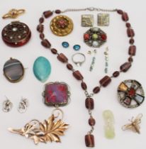 A small collection of costume jewellery to include an interesting enamel brooch and an unmounted