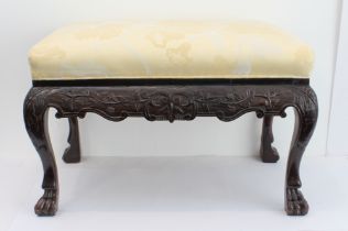 A 19th century upholstered mahogany stool: later yellow damask upholstery; the friezes and ends