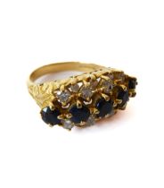 An 18ct yellow gold, sapphire and diamond three row ring - hallmarked Birm. 1992, with a central row