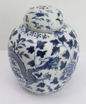 A Chinese blue-and-white ginger jar and cover decorated with dragons between foliage and painted