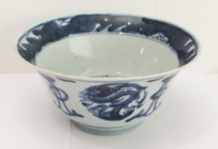 An 18th century Chinese porcelain bowl with slightly everted rim, the interior with stylised flaming