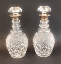 A pair of modern cut-glass mallet-shaped decanters with mushroom stoppers and silver-mounted