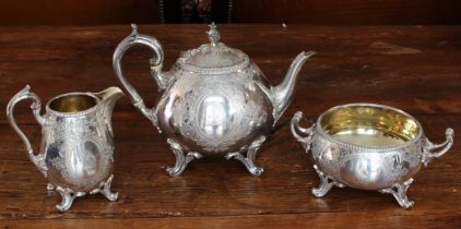 A large and heavy three-piece hallmarked silver tea service comprising teapot, two-handled sugar and