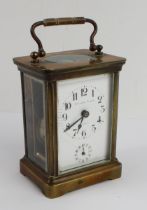 An early 20th century French glass-sided brass carriage clock: the white enamel dial (with crack)