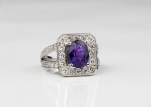 An 18ct white gold, purple sapphire and diamond cluster ring - Birm. hallmarks, maker WEB, the