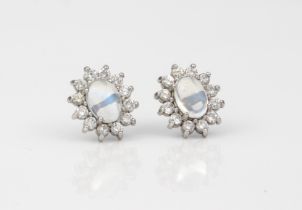 A pair of white gold, moonstone and diamond cluster earrings