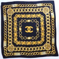 A Chanel silk scarf (approx. 85 x 90 cm). * Condition: One edge has become unhemmed, otherwise