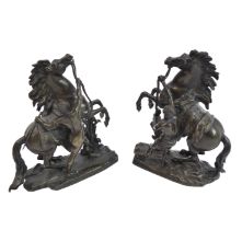 After GUILLAUME COUSTOU THE ELDER; a pair of 19th century patinated bronze Marley horses, each bears