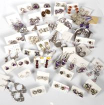 A large collection of silver earrings - to include studs and drop earrings, many set with stones