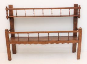 A 19th century continental oak two-tier dresser-style rack: both shelves with slender turned