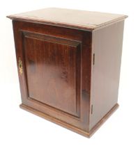A mid-18th century 'red walnut' tabletop cabinet: moulded slightly overhanging top; hinged door with