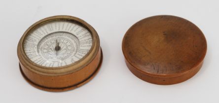 An early 19th century pocket sun-dial and compass set in a turned sycamore case: the central