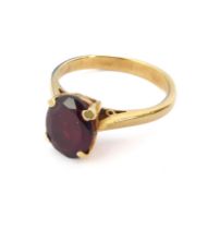 An 18ct yellow gold and pigeon blood ruby single stone ring - not marked, tests as 18ct, the approx.