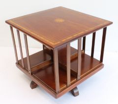 An Edwardian inlaid mahogany tabletop revolving bookcase: the square top with satinwood banding