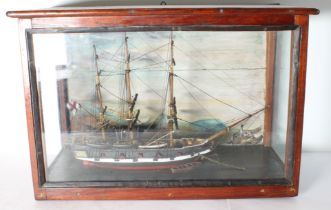 A 19th century mahogany cased and glazed scratch-built diorama-style model of an English man o'