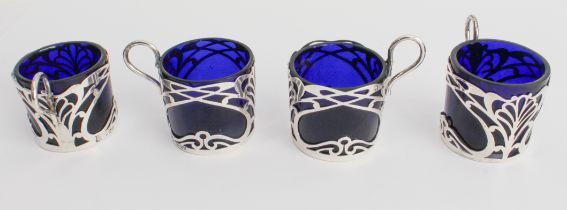 A set of four coffee cans with cobalt-blue glass liners and pierced hallmarked silver outers in