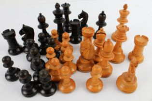 A late 19th to early 20th century boxwood and ebonised chess set within an early 20th century