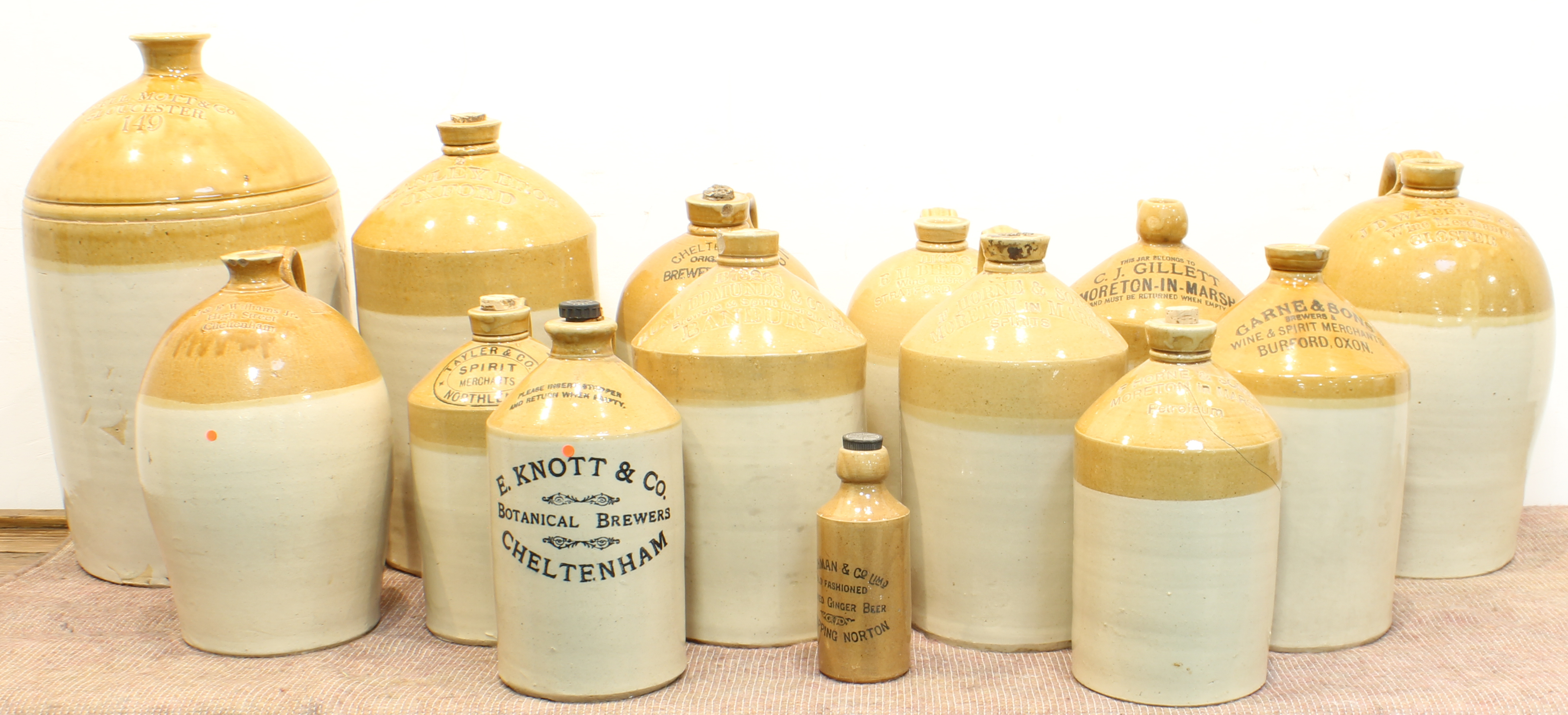 Fourteen late 19th and early 20th century jars and flagons (some with damage) to include: 'Dobell