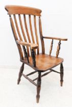 A mid to late 19th century mahogany lathe-back chair: the shaped concave tablet rail above shaped