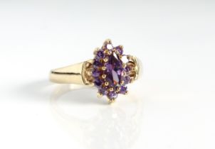 A 9ct yellow gold and purple stone cluster ring - probably amethyst, Birmingham hallmarks, the