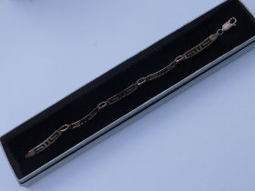 A silver bracelet modelled as five individual key frets (boxed).