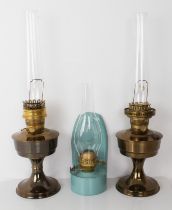 A pair of modern 'Aladdin' oil lamps and glass funnels, together with an earlier French style wall