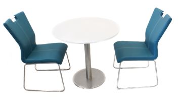 A bistro table and two chairs. - the table with circular white composite marble top and on stainless