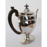 A large and heavy hallmarked silver coffee pot in 18th century style (later): high carved wooden